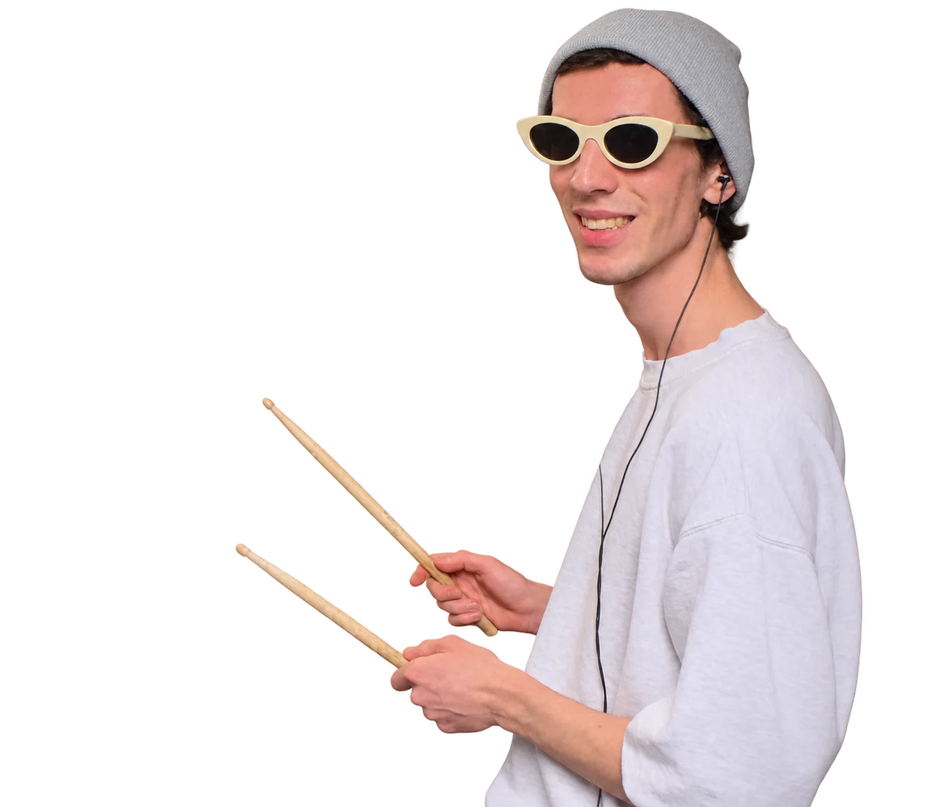 Ivan smiling in the recording studio, holding drumsticks