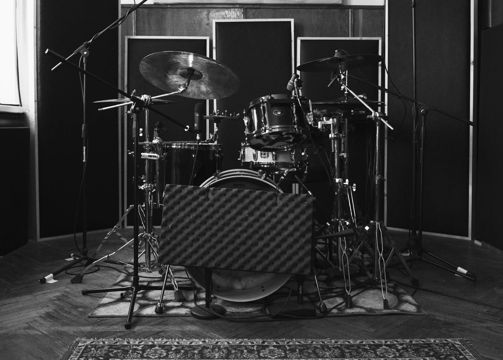 Ivan's acoustic drum kit set up with microphones in a recording studio